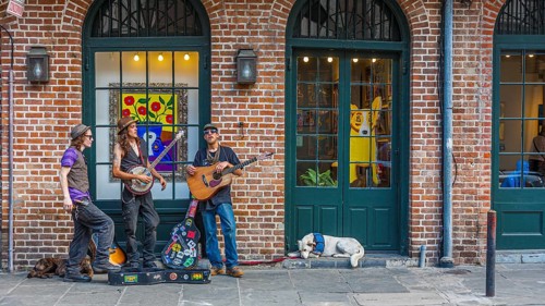 Street performers playing music on sidewalk in the French Quarter of New Orleans, Louisiana, USA,