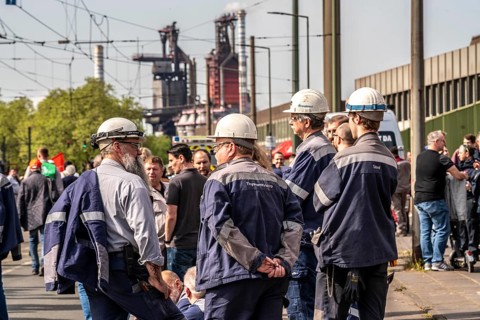 Steelworkers at a demonstration in front of the headquarters of ThyssenKrupp Steel Europe in