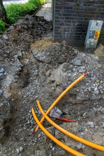 Laying of fibre optic cables, empty conduits are laid under a pavement, in which the actual fibre
