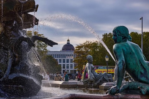 Water fountain of the Neptune Fountain backlit with Berlin Cathedral, Spandauer Straße, Berlin,