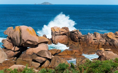 Rock formations in the sea with foaming waves under a blue sky, Ploumanac'h, Ploumanach,