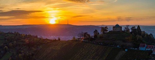 Sunset at the burial chapel on the Württenberg, the television tower on the horizon. Aerial view,
