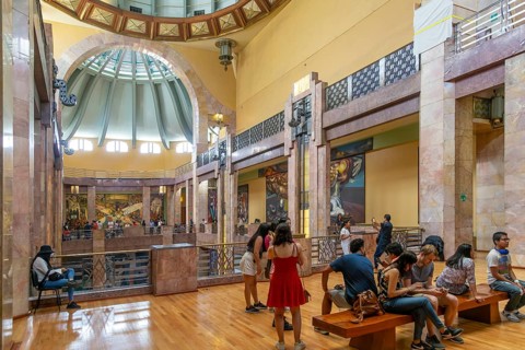 People viewing artwork murals inside Palacio de Bellas Artes, Palace of Fine Arts, Mexico City,