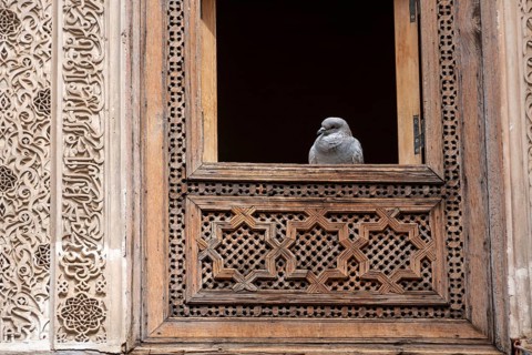 Rich decorated facade in the courtyard of the Medersa Attarine in Fes, Morocco, Africa