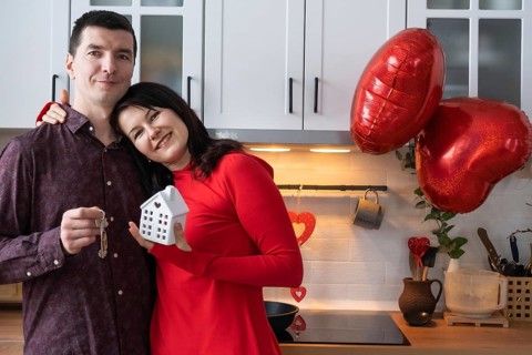 Man and woman in love date at home in kitchen with keys of house. Valentine's Day, happy couple,