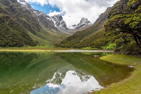 Tranquil mountain lake Mackenzie at the famous Routeburn Track, Fiordland National Park, South