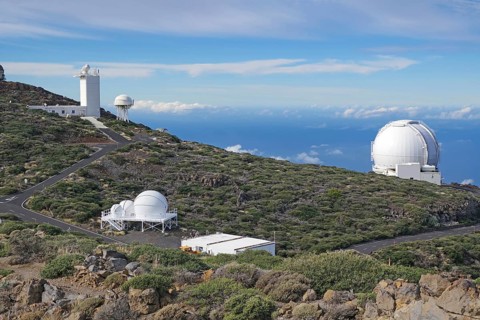 An observatory is located on a mountain under a wide blue sky, no light pollution, Observatory,
