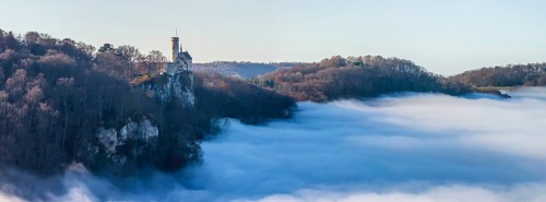 Sunshine in the mountains, fog in the Echaz valley. Lichtenstein Castle in the Swabian Alb. The