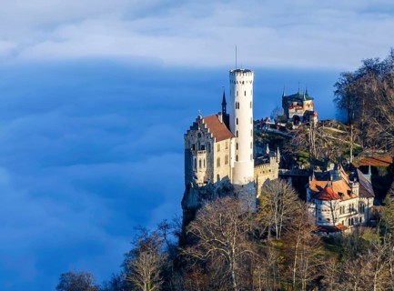 Sunshine in the mountains, fog in the Echaz valley. Lichtenstein Castle in the Swabian Alb. The