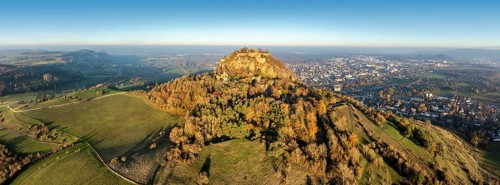 Aerial view, panorama of the volcanic cone Hohentwiel with the castle ruins illuminated by the