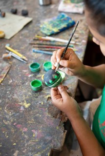Sri Lankan woman painting a wooden ball, Oak Ray Woodcarvings, Naula, Matale, Central Province, Sri