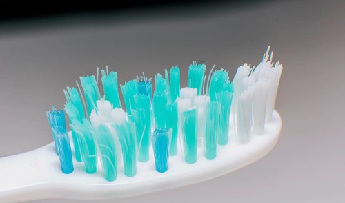 Toothbrush with used bristles. Close up of a used toothbrush