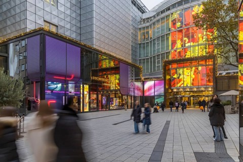 Porsche Brand Store and Breuninger department stores' in the evening. Shops with logos in the