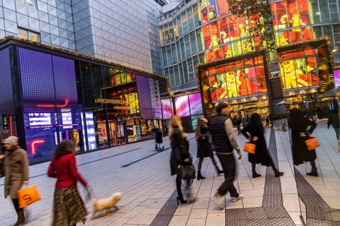 Porsche Brand Store and Breuninger department stores' in the evening. Shops with logos in the