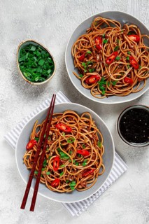Udon noodles, with shimeji mushrooms, vegetables, in sauce, with sesame seeds, green onions, Asian