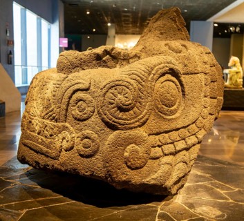Monumental Xiuhcoatl stone sculpture of fa ire serpent, archaeological site and museum of Templo