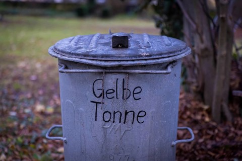 An old GDR rubbish bin has been declared a yellow bin. Possendorf, Saxony, Germany, Europe