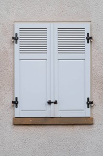 Windows with grey metal shutters