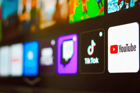 In this photo illustration the YouTube, TikTok and Twitch logo is displayed on a TV screen