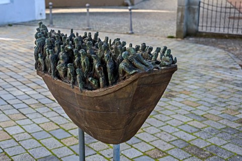 Figures in a boat, bronze artwork at the former collegiate church of St Peter, a Roman Catholic