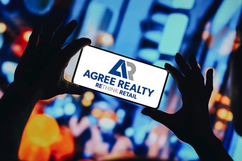 In this photo illustration, the Agree Realty Corporation logo is displayed on a smartphone screen