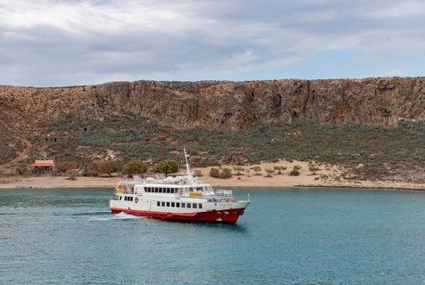 A picture of a ferry next to the Gramvousa Island