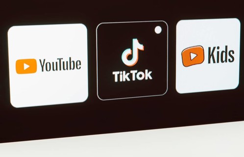 In this photo illustration the YouTube, TikTok, YouTube Kids logo is displayed on a TV screen