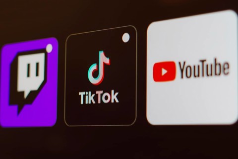 In this photo illustration the TikTok, Twitch and YouTube logo is displayed on a TV screen