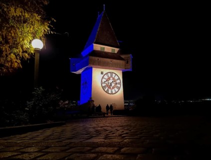 The famous Clock Tower (Grazer Uhrturm) on Shlossberg hill, Graz, Styria region, Austria, by night,