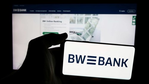 Stuttgart, Germany, 07-15-2024: Person holding mobile phone with logo of German company