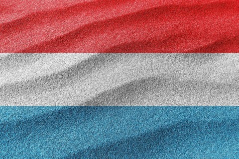 Luxembourg sand flag, national flag sand background