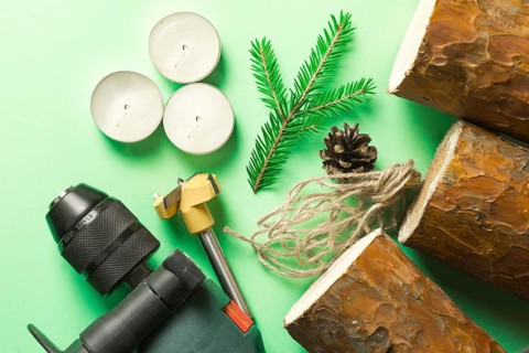 DIY Christmas candle holder made of pine logs, candles, craft rope, fir branches and cones. Layout