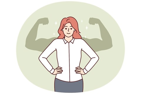 Successful businesswoman stands with hands on waist imagining giant muscular arms behind back.