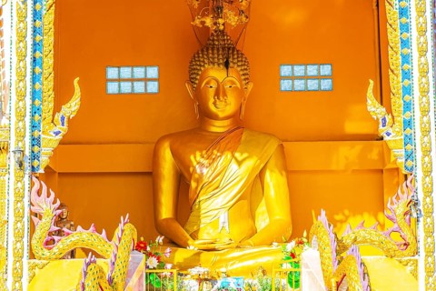 Golden Big Buddha statue in holy shrine in Wat Phadung Tham Phothi temple in Khao Lak Phang-nga