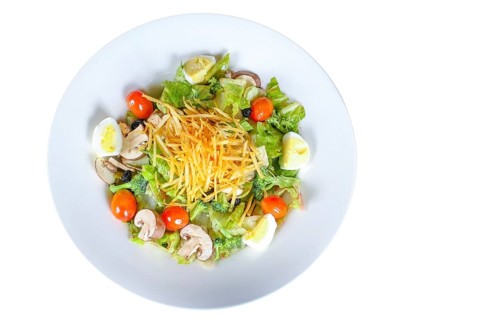 A plate featuring a Cobb Salad with a medley of fresh ingredients, including lettuce, mushrooms,