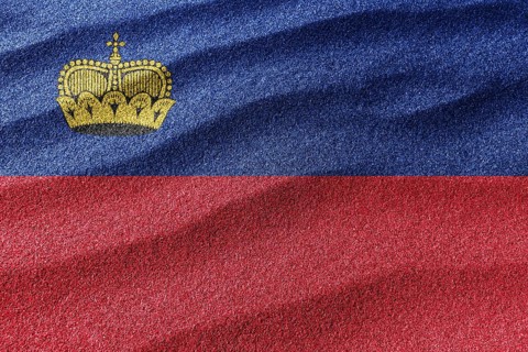 Liechtenstein sand flag, national flag sand background