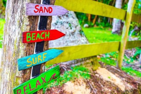 Sand beach surf and relax on colorful directional wooden arrows on the Mangrove beach and Pouso