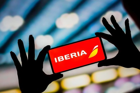 In this photo illustration, the Iberia logo is displayed on a smartphone screen