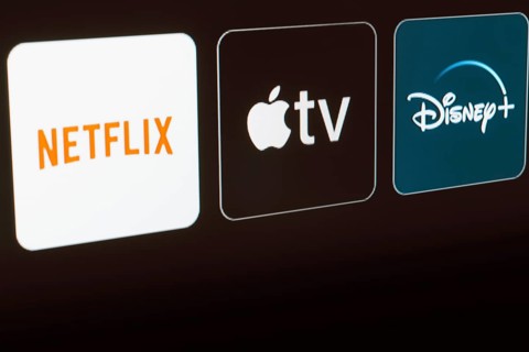 In this photo illustration the Netflix, Apple TV and Disney Plus logo is displayed on a TV screen