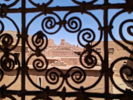 Ornate traditional window grid of a berber house ruin in the city center of Amezrou, Morocco,