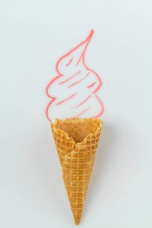 Ice cream with real waffle cone and hand drawn cream. Vertical shot white background