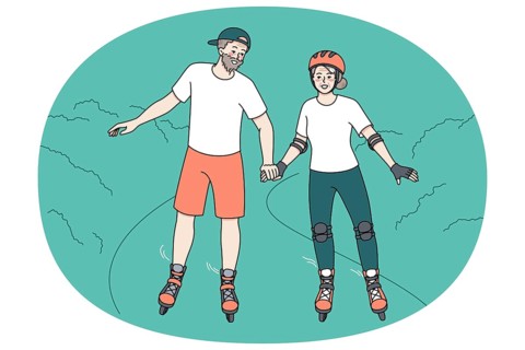 Happy mature couple have fun on roller blades on weekend in park. Overjoyed active energetic