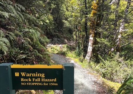 Warning sign about falling rock at famous Routeburn Track, South Island of New Zealand