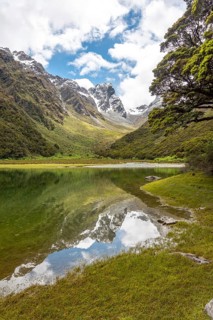 Tranquil mountain lake Mackenzie at the famous Routeburn Track, Fiordland National Park, South
