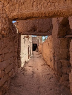 Typical abandoned alleyway surrounded by old clay walls in a little village somewhere in the Draa