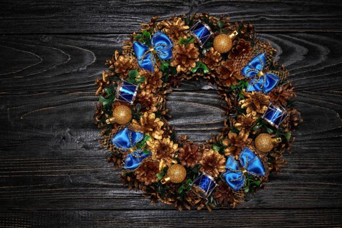 Christmas wreath on dark wooden background