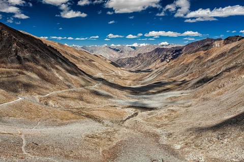 View of Karakoram range and road in valley from Kardung La, the highest motorable pass in the world