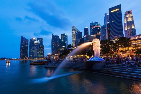 SINGAPORE, JANUARY 1, 2014: Night view of Singapore Merlion at Marina Bay against Singapore skyline