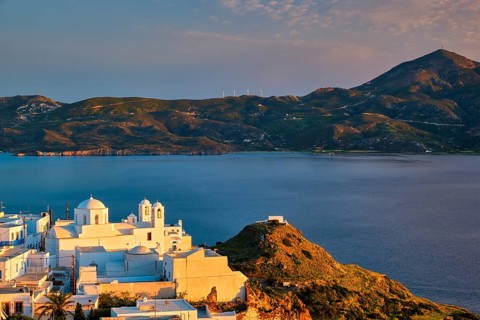 View of Plaka village on Milos island with traditional greek white houses with Greek Orthodox