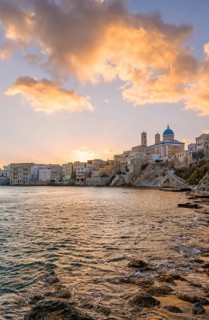 View of the village with the Greek Orthodox church of Agios Nikolaos, Asteria Beach, at sunset with
